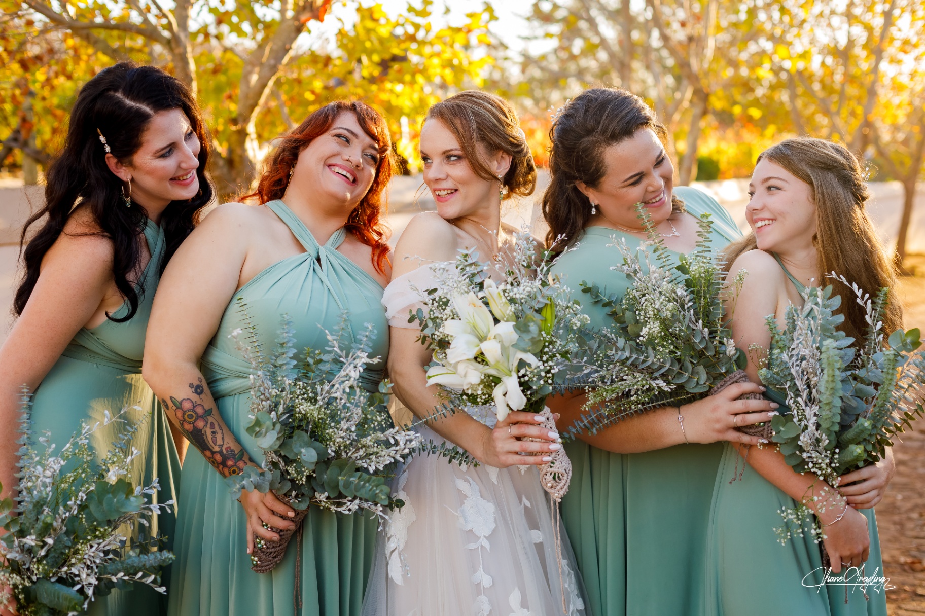 Bride with bridesmaids outdoors