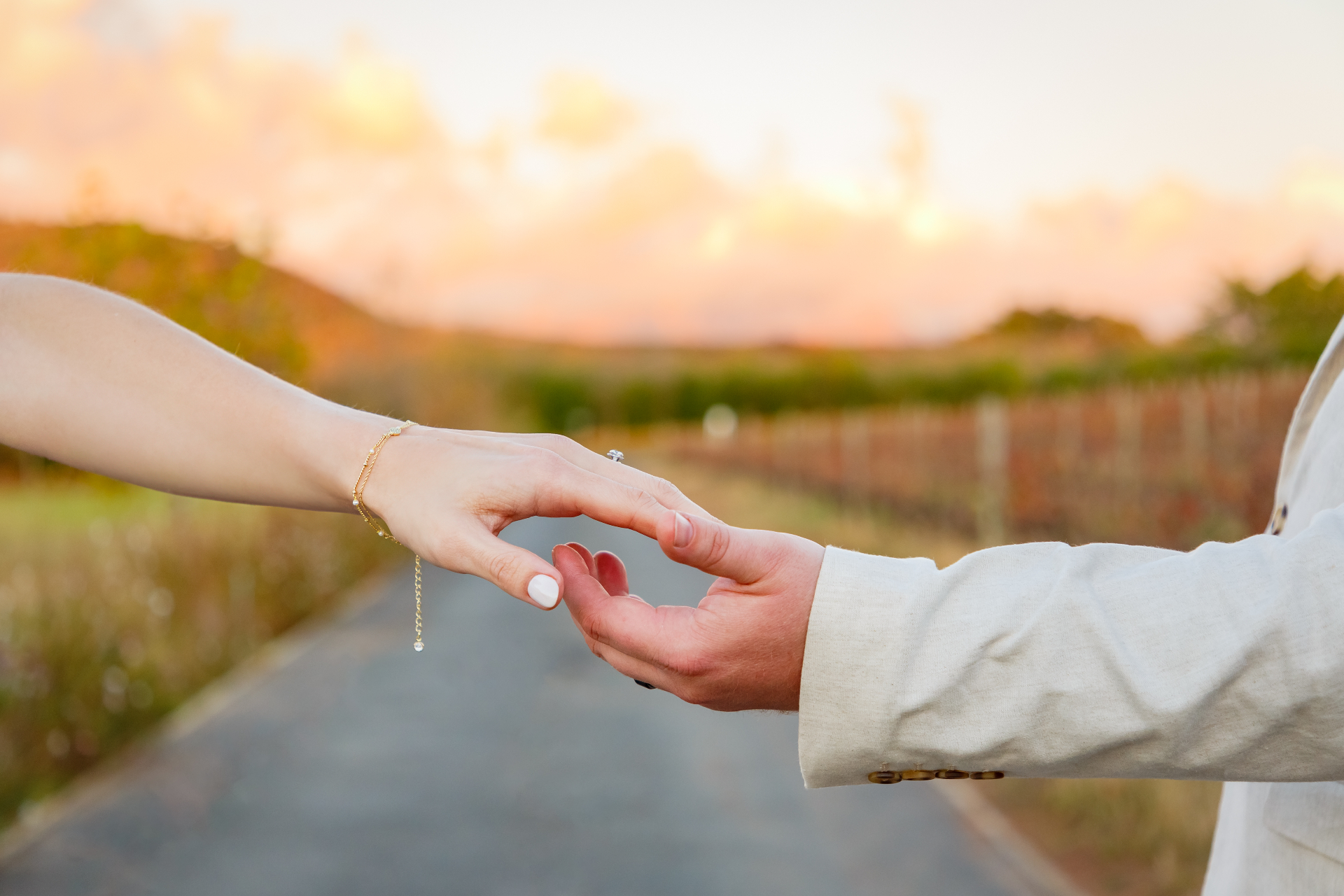Couple holding hands sunset